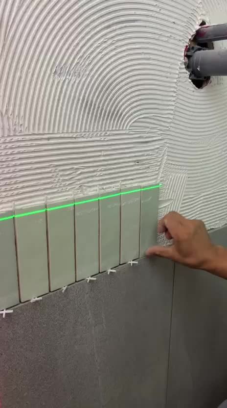 Video: setting green glazed tile to a laser line